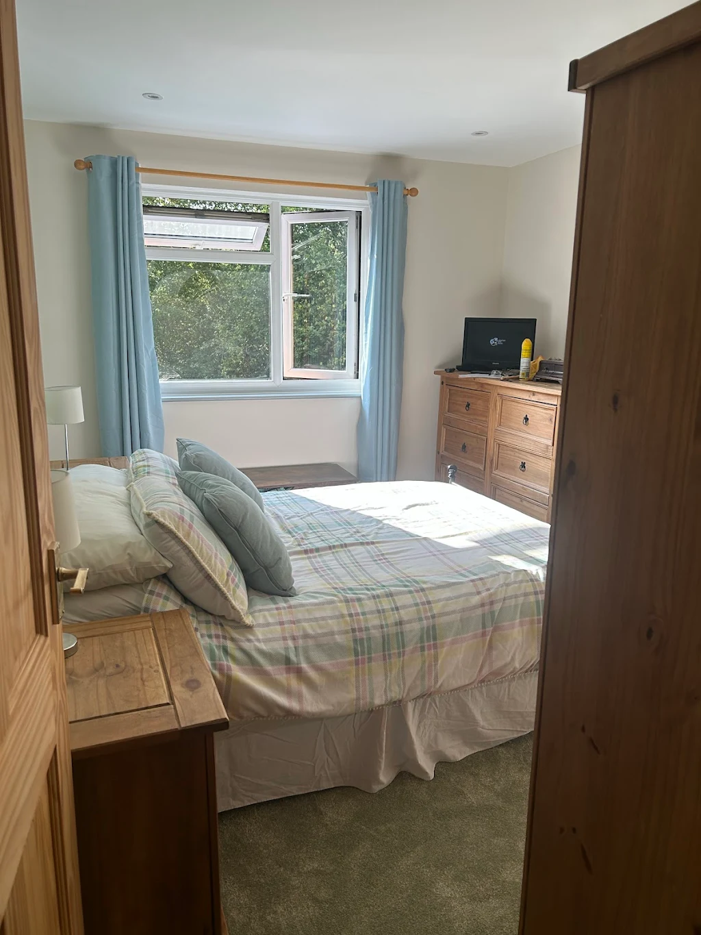 Bright modern bedroom with plaid bedding