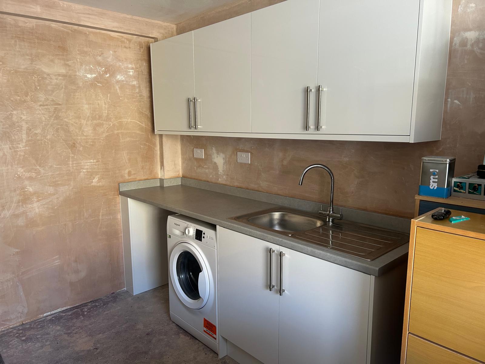 Garage converted to a utility room with fitted units and sink