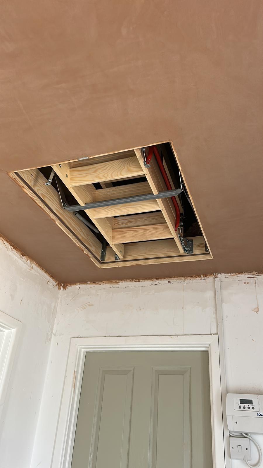 Loft hatch open with new folding loft ladder installed