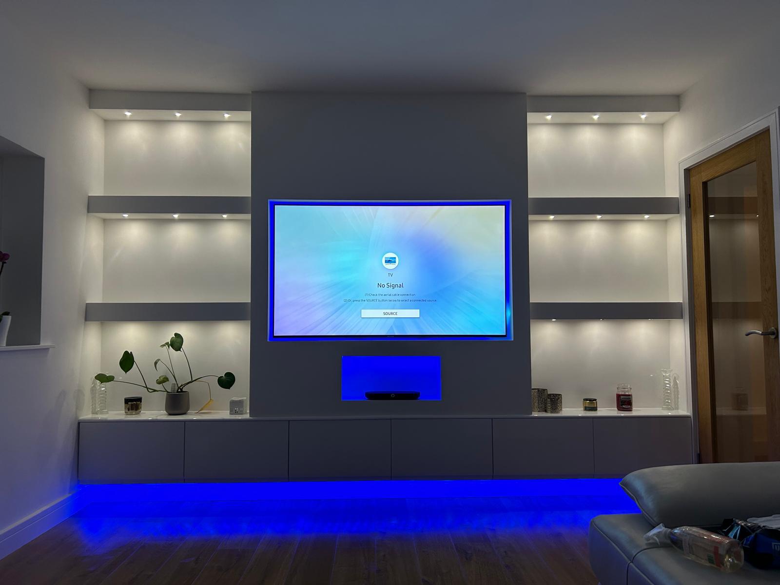 Bespoke TV media wall with recessed lighting and floating cabinets