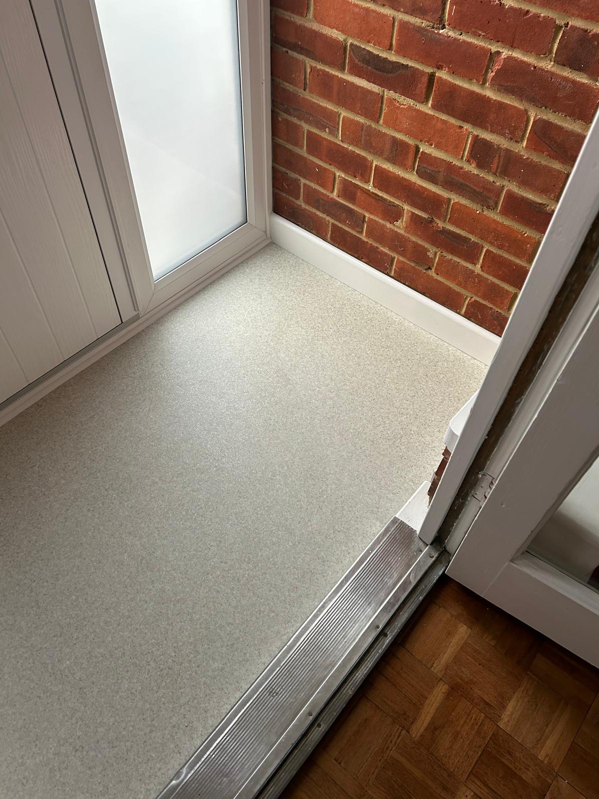 Porch entrance with new flooring, fresh skirting and exposed brick wall