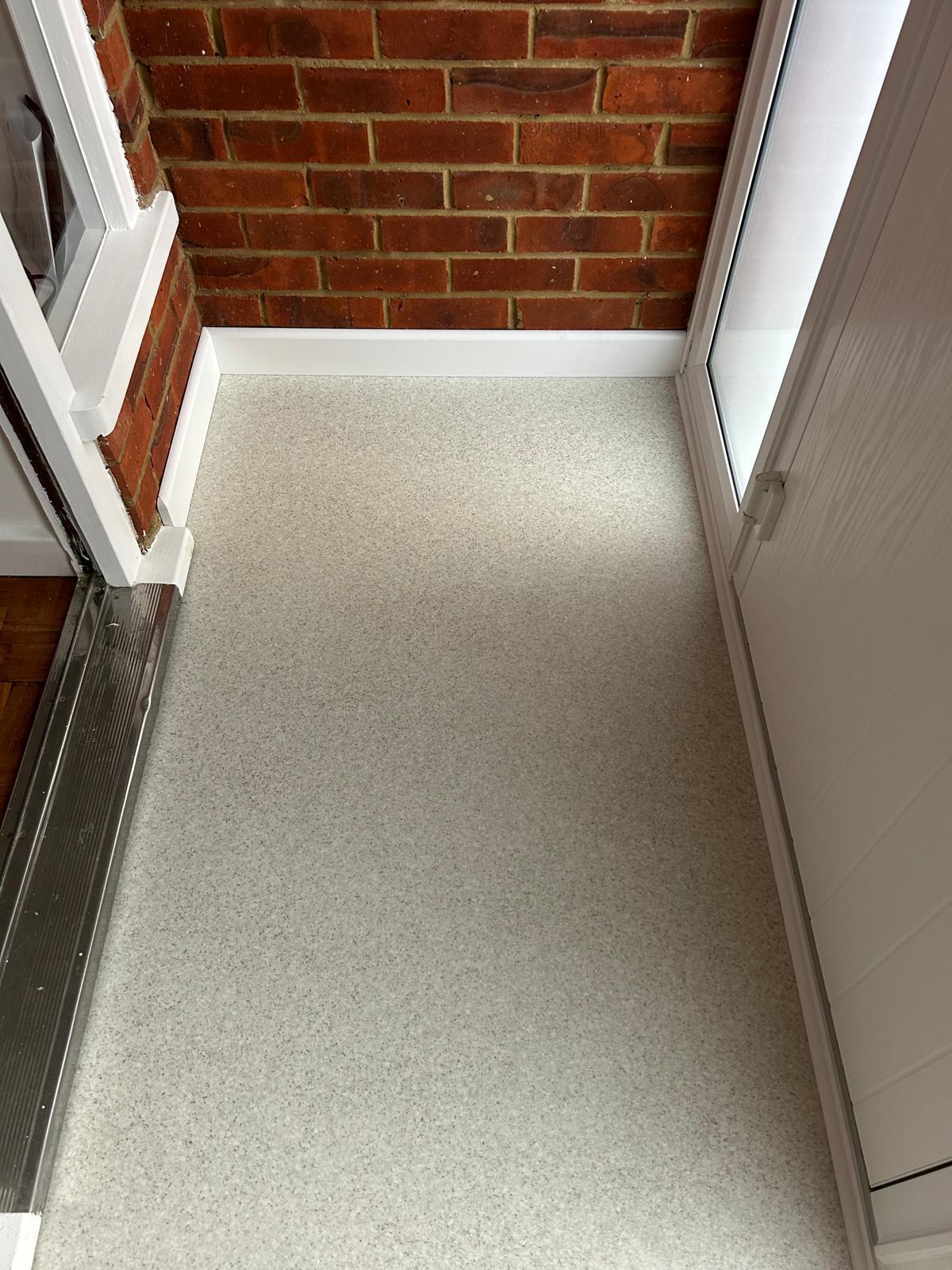 Newly laid porch floor with crisp skirting boards and brickwork